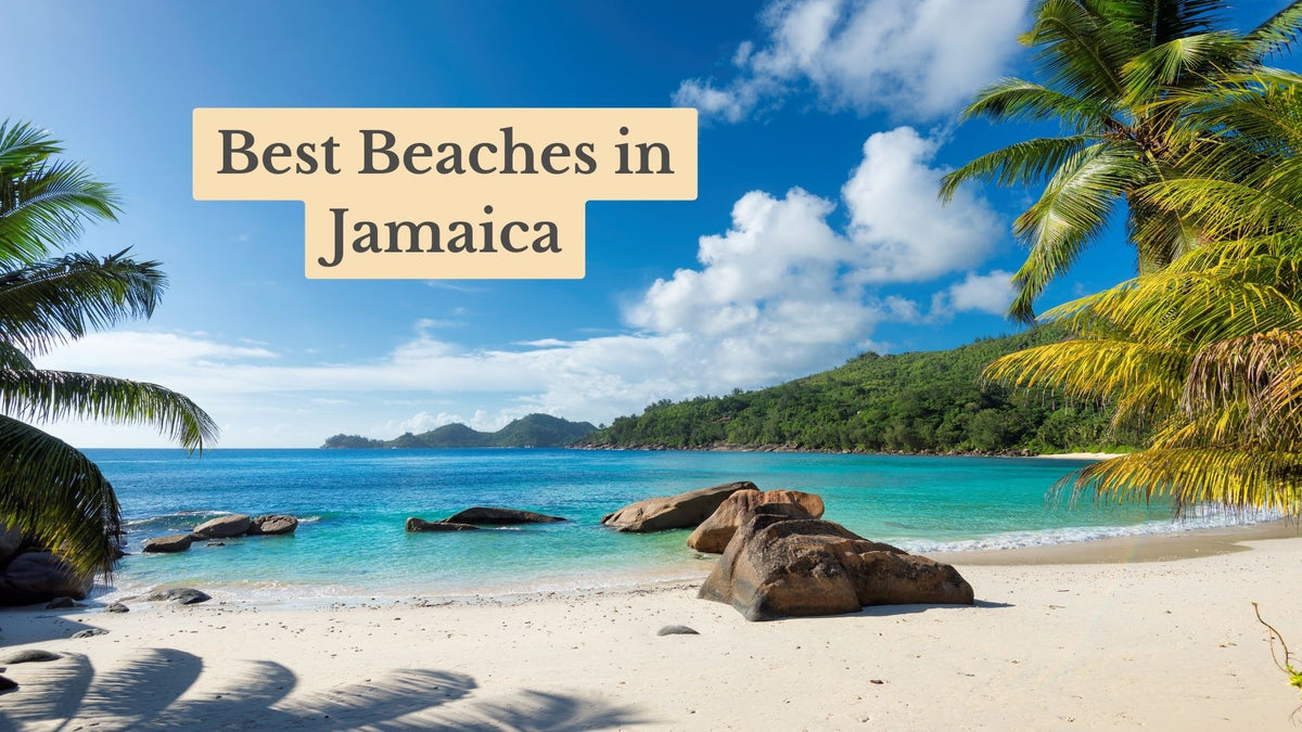 Title card "Best Beaches in Jamaica" over a white sand beach with boulders, turquoise water, palm fronds and a green headland.