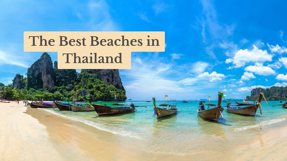Title card "The Best Beaches in Thailand" over longtail boats moored in turquoise water beside a sandy beach and a forested limestone cliff.