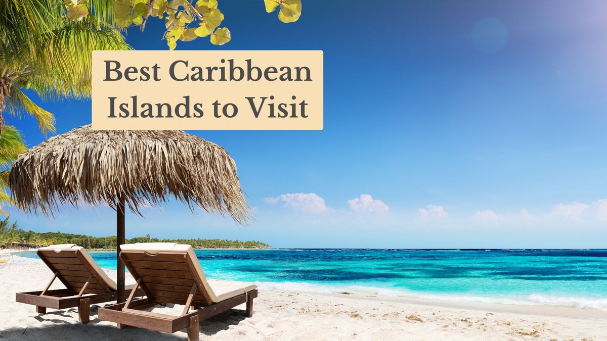 Two wooden loungers under a thatched umbrella on a white sand beach by turquoise water, titled "Best Caribbean Islands to Visit"