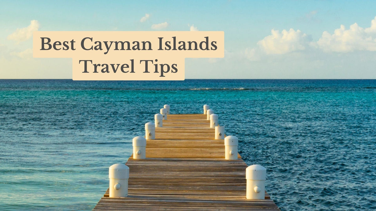 Wooden pier with white posts stretching into turquoise sea under a blue sky, titled "Best Cayman Islands Travel Tips"