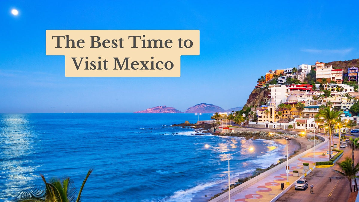 Cover reading "The Best Time to Visit Mexico" over a dusk view of a lit seaside promenade and colorful hillside buildings by the ocean.