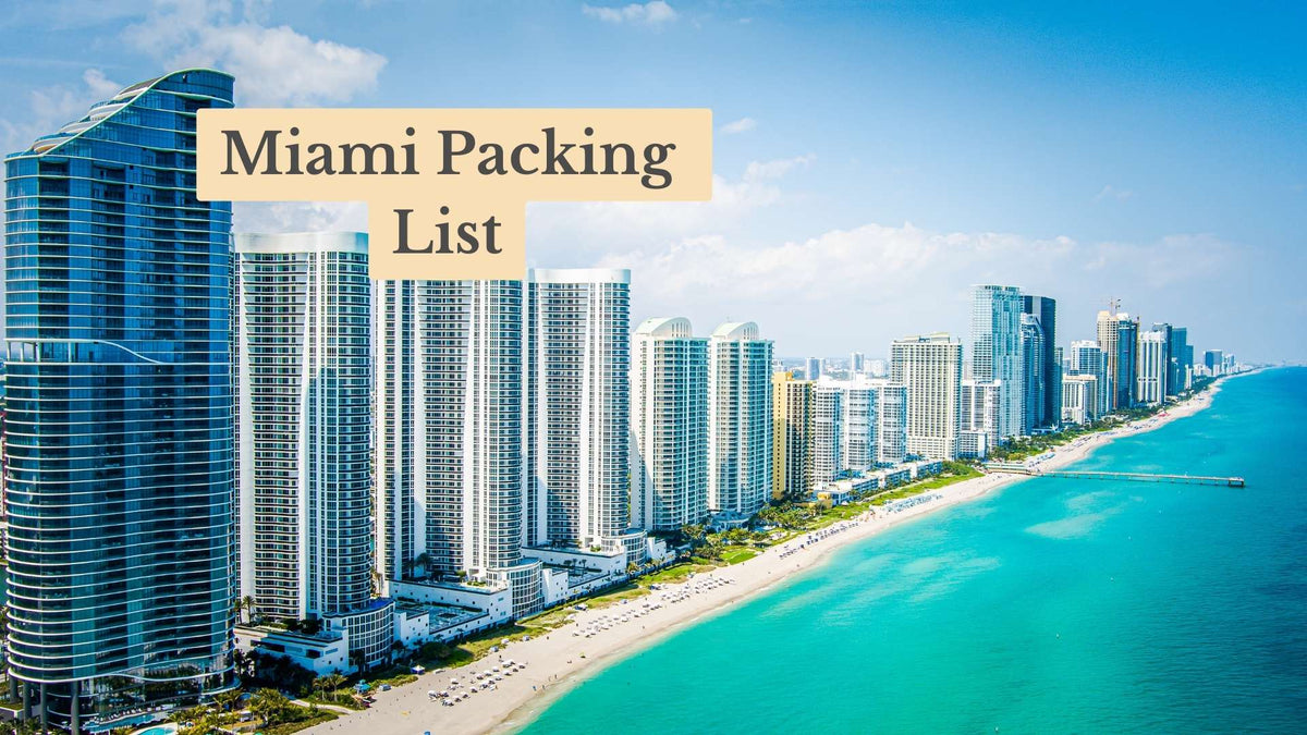 Aerial view of high-rise condo towers along a white sand beach and turquoise sea, titled "Miami Packing List"