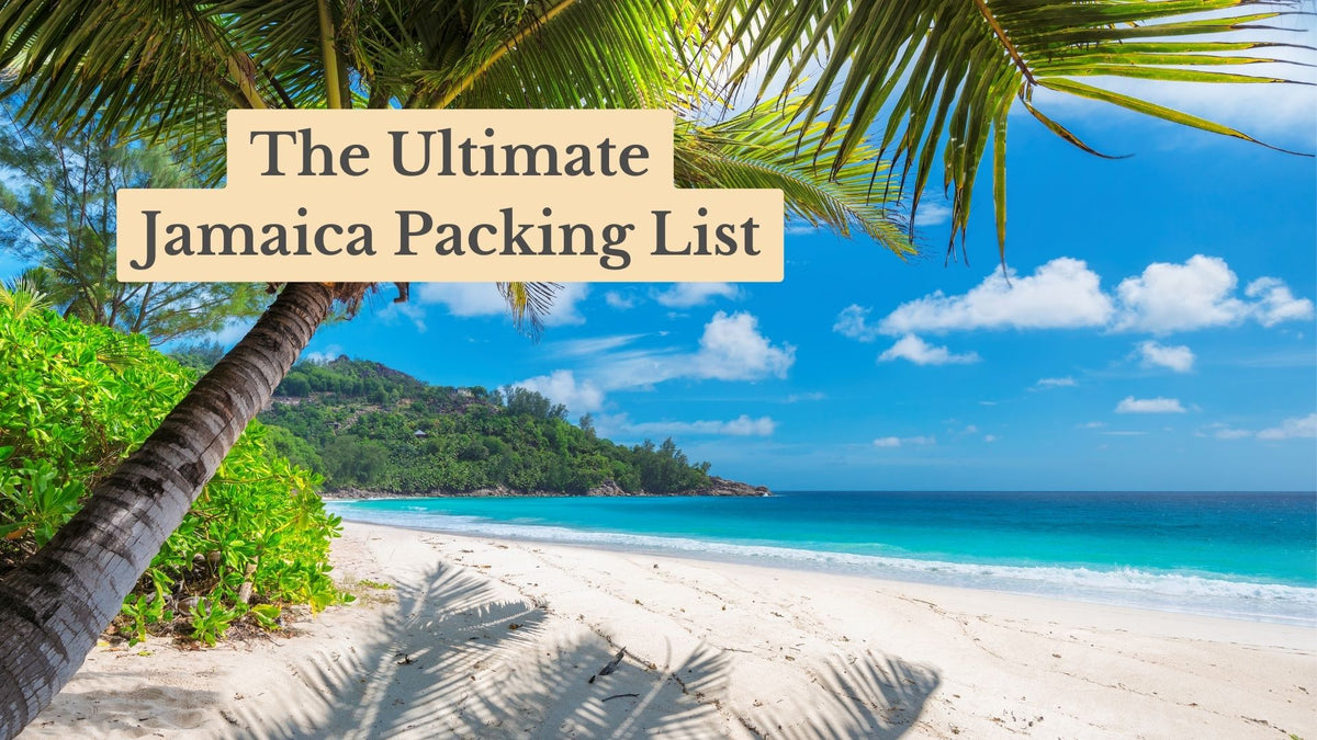 Title card "The Ultimate Jamaica Packing List" over a white sand beach with turquoise water, a leaning palm tree and a green headland.
