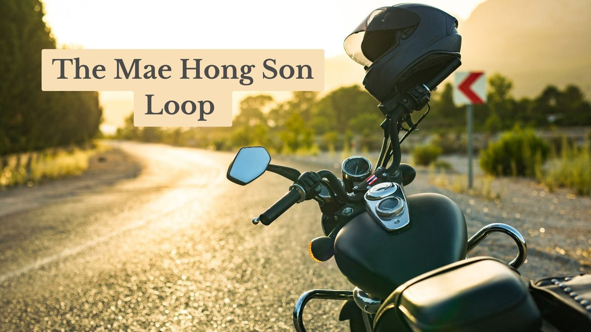 Title card "The Mae Hong Son Loop" over a motorbike with a helmet on its handlebar, parked beside a curving road at sunset