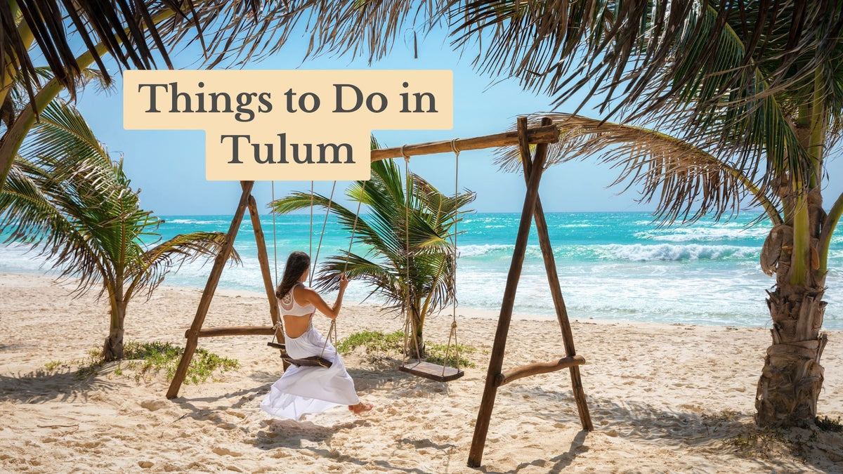 Woman in white sits on a wooden beach swing facing turquoise surf, under palms, with the title text "Things to Do in Tulum"