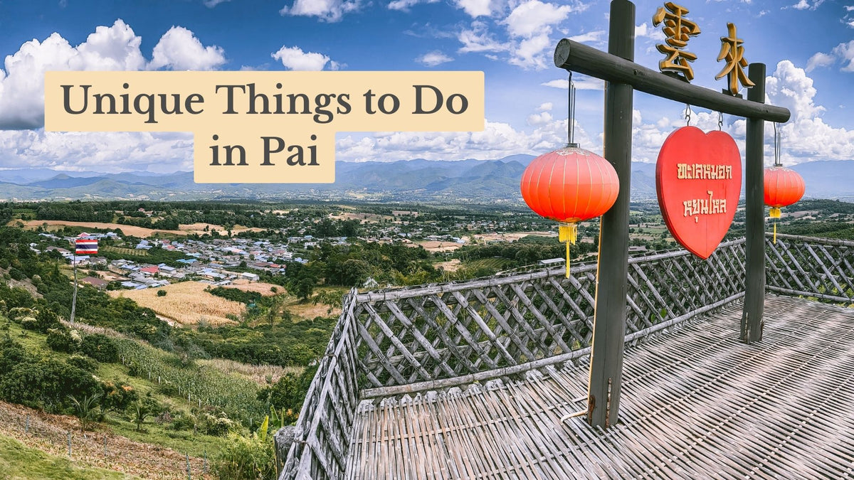 Title card "Unique Things to Do in Pai" over a bamboo lookout with red lanterns and a heart sign above a town and mountains.