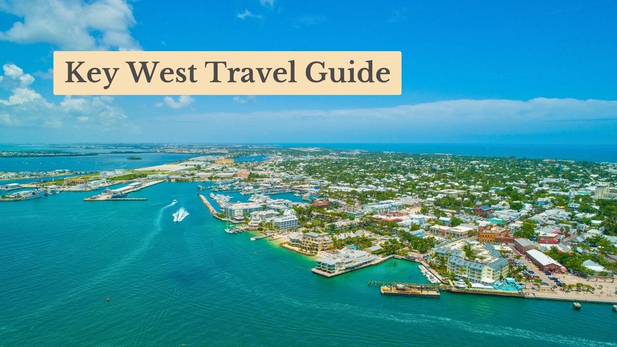 Aerial view of Key West's waterfront, piers and town beside turquoise water, with the title "Key West Travel Guide"