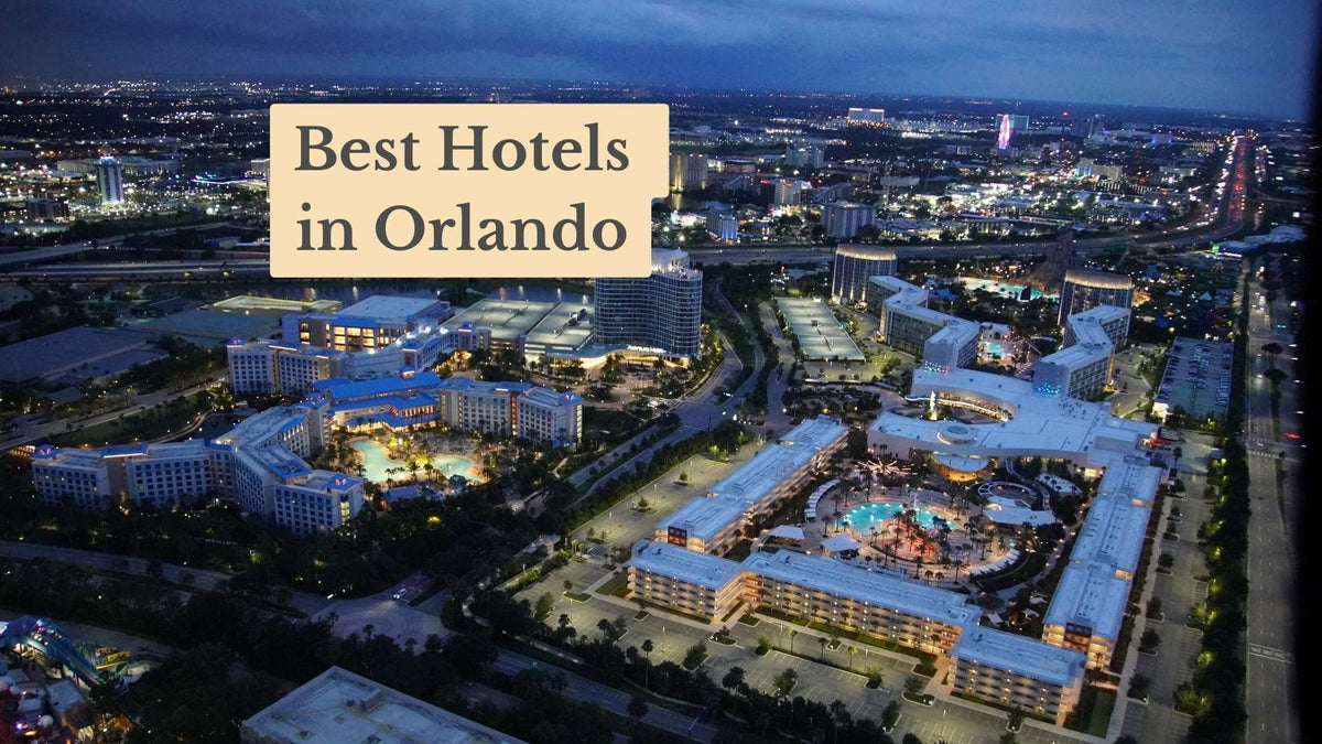 Aerial view at dusk of lit hotel resorts with pools and a busy highway, with the title "Best Hotels in Orlando"