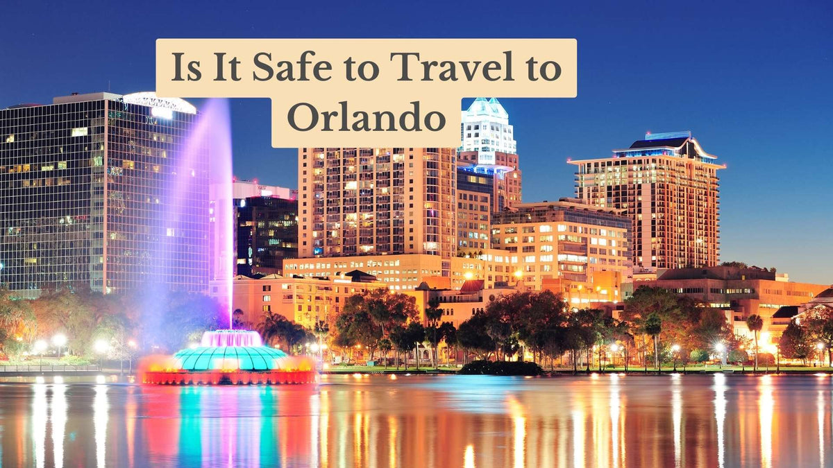 Title card "Is It Safe to Travel to Orlando" over a dusk skyline with a lit fountain reflected in the lake.