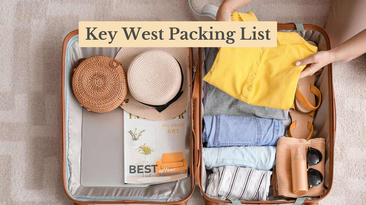 Key West Packing List: open suitcase holding a straw hat, woven bag, magazine, folded clothes, sandals, sunglasses and sunscreen.